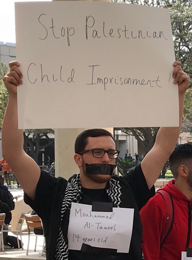 The silent protest featured students with a name of a Palestinian child imprisonment victim. Justice Lovin, The Paisano