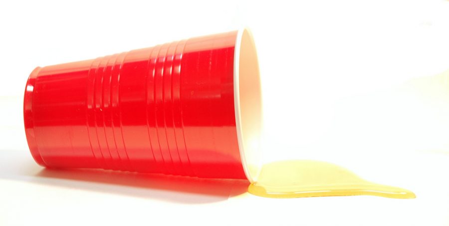 image of the iconic red drinking cup spilling alcohol.