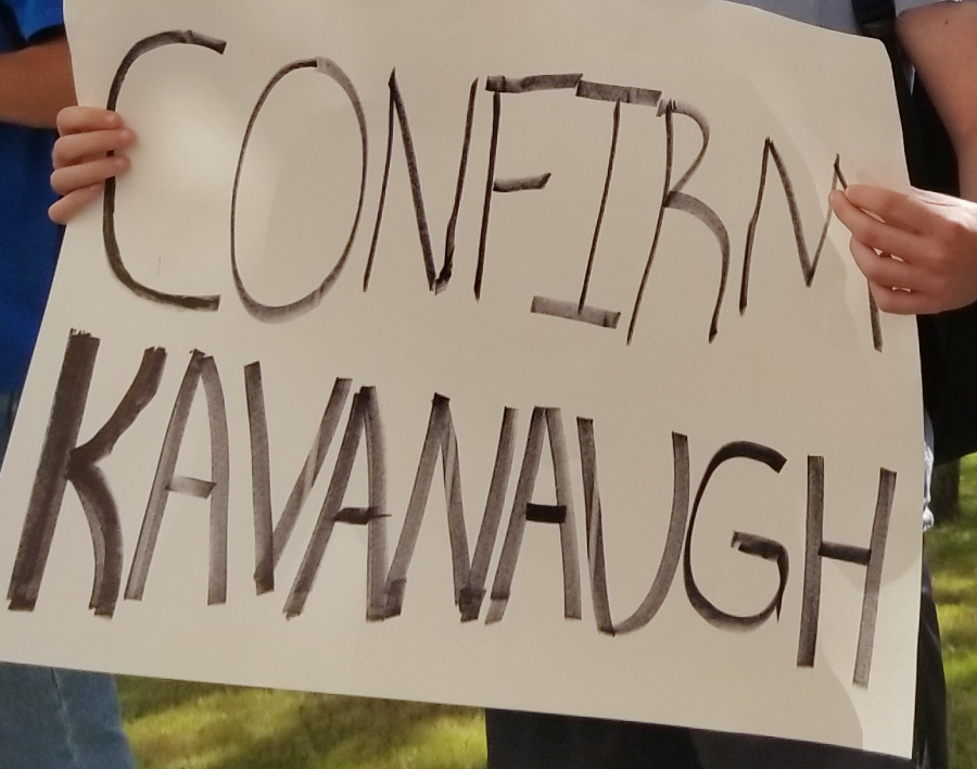 A sign made by a protestor: Confirm Kavanaugh