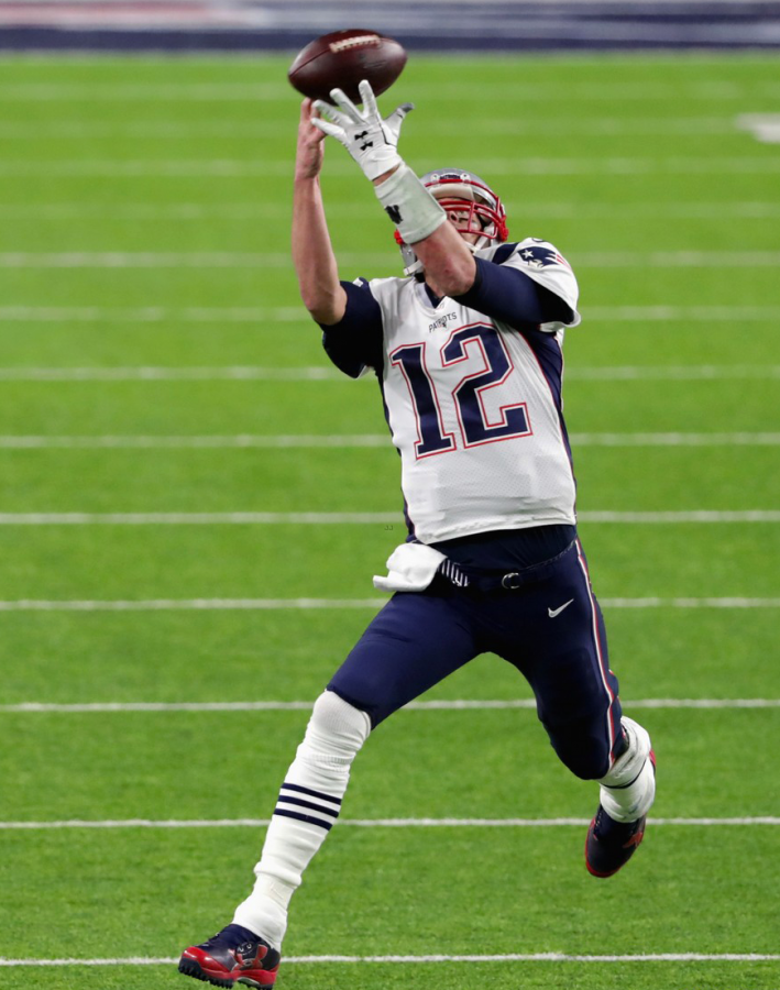 QB Tom Brady attempts to catch a pass.