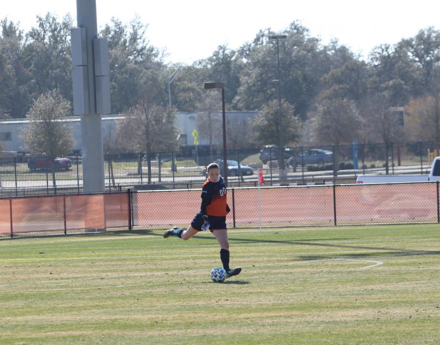 Jil Schneider clears the ball away during a game earlier this season. The sophomore keeper has appeared in all eight games for the Runners this season, starting in seven of them.