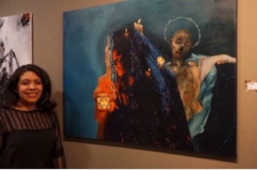 Elexis Hernandez posing beside her painting “Insomnia.”