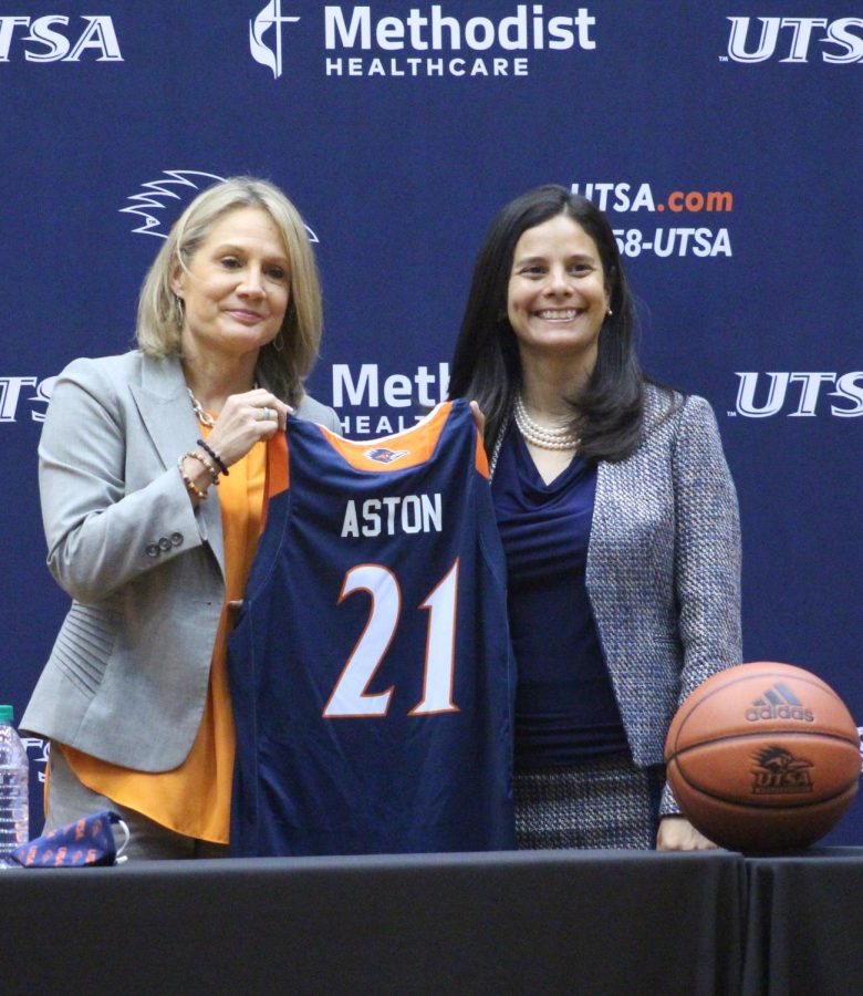 Karen Aston and Dr. Campos pose for pictures at Astons introductory press conference. Aston holds a career record of 285-146 and was the previous head coach at the University of Texas.