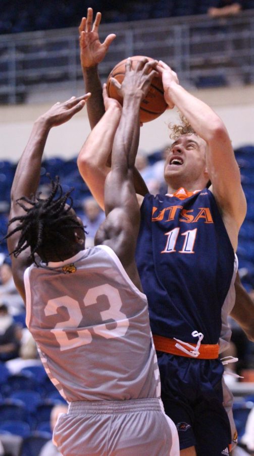 Lachlan Bofinger fights through contact to get a shot off during a game against IUPUI earlier this season. Bofinger has appeared in all 18 games for UTSA so far this season and has drawn four starts while averaging three points and 4.1 rebounds per game.
