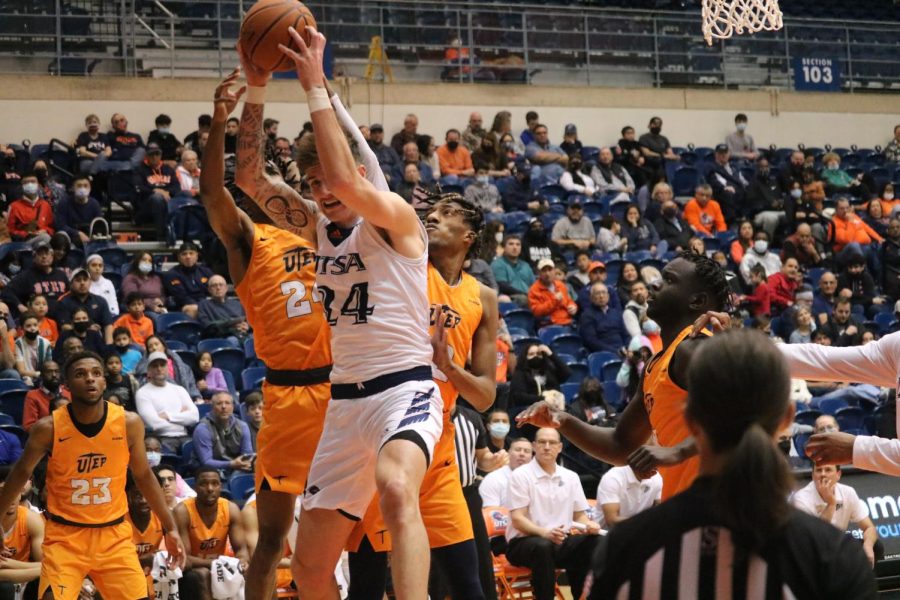 Jacob Germany fights off a swarm of UTEP defenders to pull down a rebound during a game against the Miners last week. Germany has enjoyed a standout junior season and is currently averaging 16 points and 6.9 rebounds per game.