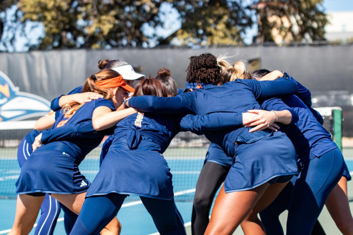 The team gathers ahead of their doubles matches for a pre-match huddle.