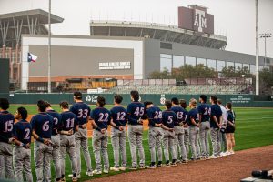 The team stands for the National Anthem at Blue Bell Park.