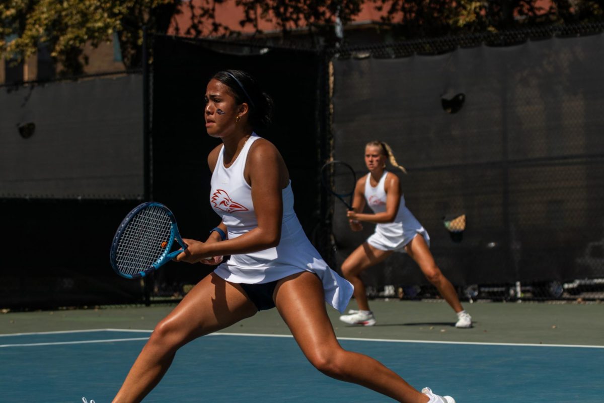 Valeria Sanchez (left) and Arina Babenko (right) wait for their opponent to serve.