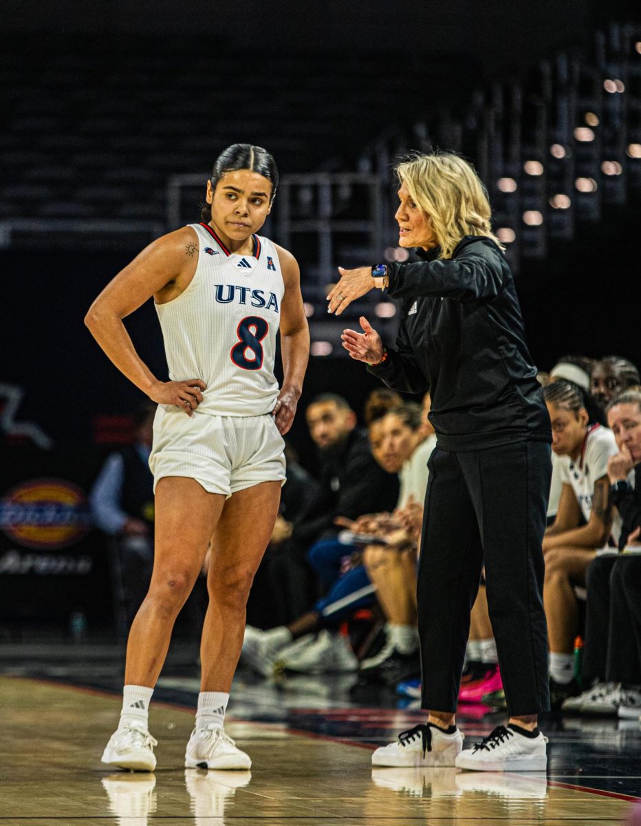 Coach Karen Aston speaks to Nina De Leon Negron.
