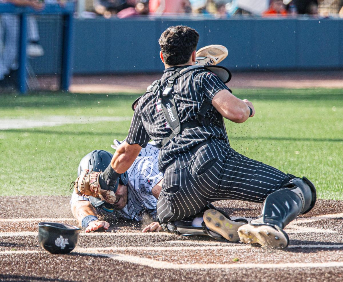 James Taussig dives for home base.